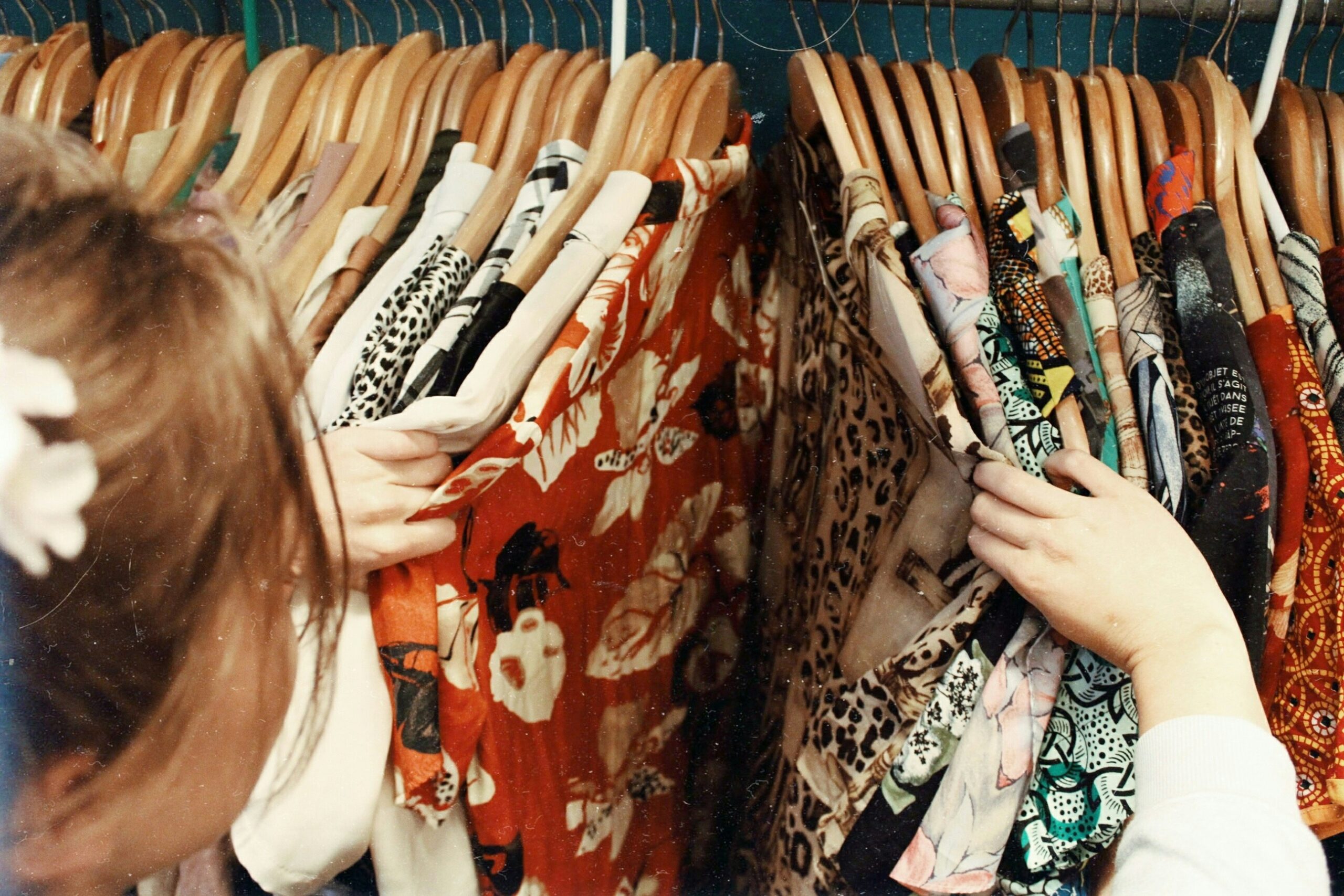 Woman browsing through a rack of shirts while clothes shopping in Tokyo, Japan.
