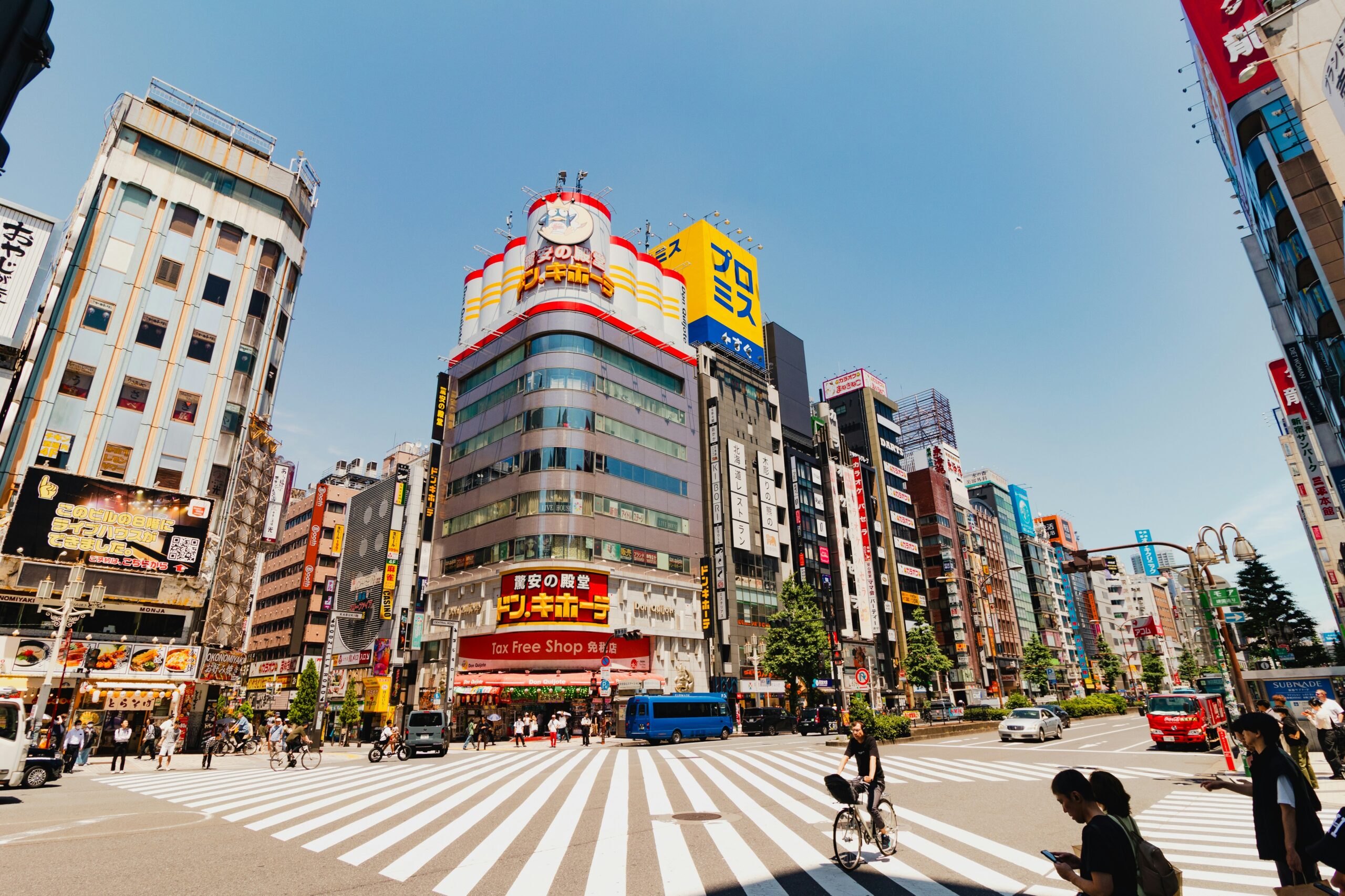 Don Quijote store on a sunny day by a large crosswalk intersection in Tokyo