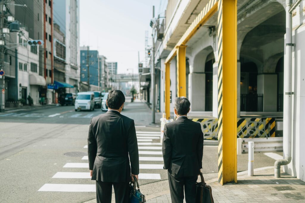 Class is always in session: Lessons from living in Japan 3 Two Japanese businessmen seen from behind, waiting at a crosswalk in Tokyo, Japan