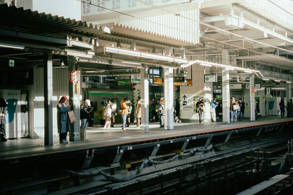 Class is always in session: Lessons from living in Japan 2 Commuters waiting on a platform at Shibuya Station in Tokyo, Japan, capturing the rhythm of daily life.